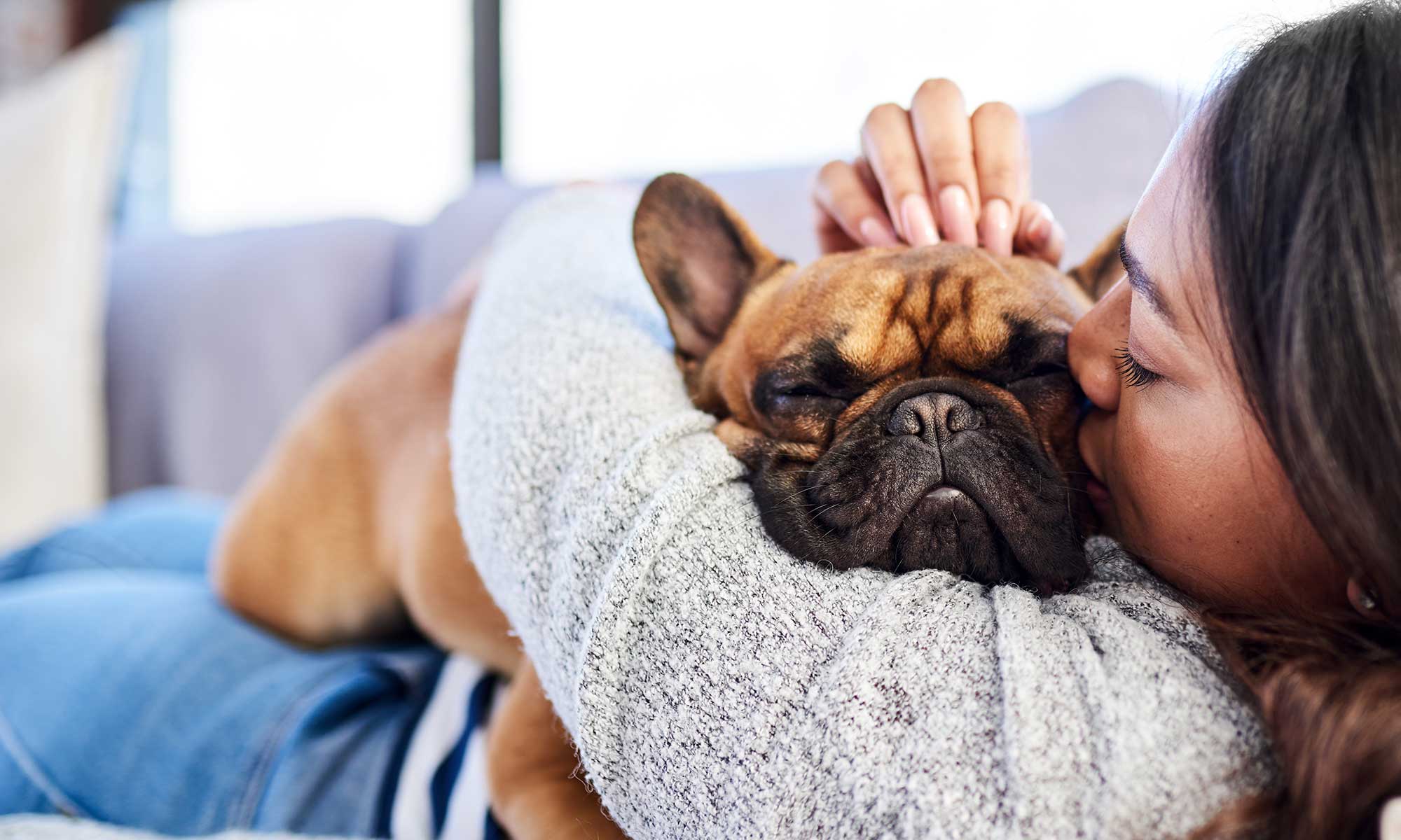 A woman hugging her dog